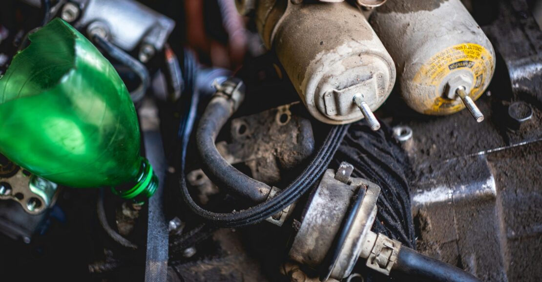 a close up of a car engine with a green light